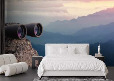 Binocular on top of rock mountain at sunset Wall mural