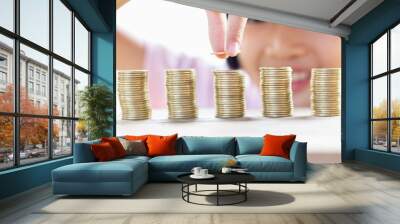 Child stacking coin on desk, Invest your money to get in come,growing business and future concept Wall mural