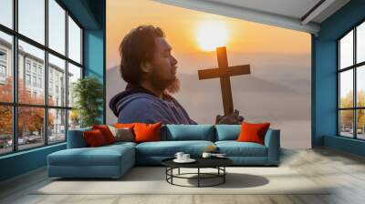 Christian, Christianity, Religion copy space background. male with beard holding christian cross for worshipping God at sunset background.silhouette. Wall mural