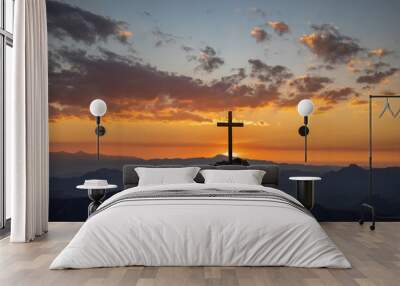 Christian cross on top rock mountain with bright sunbeam on the colorful sky background. Christian background concept Wall mural