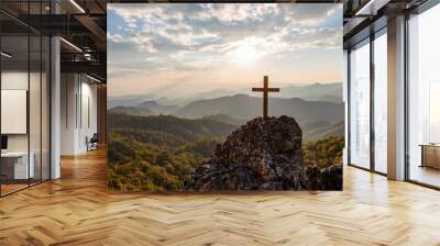 Crucifix symbol on top rock  mountain with bright sunbeam on the colorful sky background. Silhouettes Wall mural