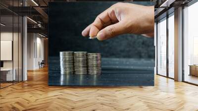 hand stacking coins on desk, investment and financial concept Wall mural