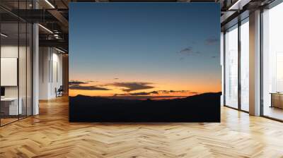 Heaven at early morning with copy space. Sunset, sunrise backdrop.Predawn clear sky with orange horizon and blue atmosphere. Smooth orange blue gradient of dawn sky. Wall mural