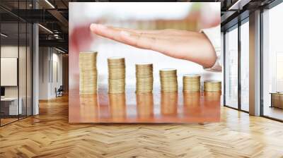 human hand protective coin stack  on wooden table, saving and investment idea concept, Wall mural