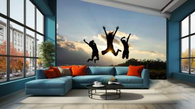 Silhouette group of happy children jumping playing on mountain at sunset, summer time Wall mural