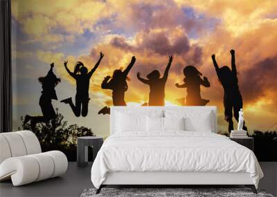 silhouette of friends girls group jumping playing at sunset time Wall mural