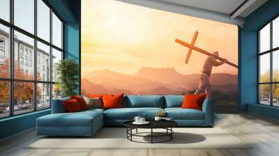 Silhouette of human carry cross on mountain sunset Wall mural