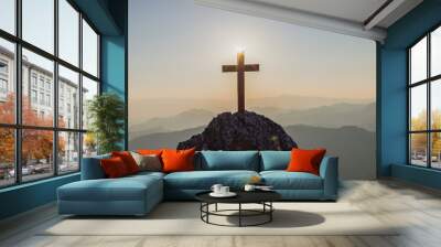 silhouettes of crucifix symbol on top mountain with bright sunbeam on the colorful sky background Wall mural