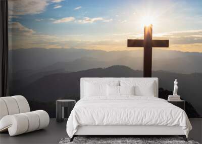 Silhouettes of crucifix symbol with bright sunbeam on the colorful sky background Wall mural