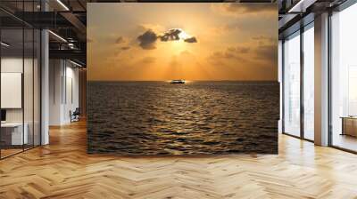 Sunset on Maldives island with boat, view from water villas resort. Nature and travel  concept. Wall mural