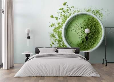 A bowl of fresh matcha green tea powder with scattered powder on a light background, representing a minimalist aesthetic of Japanese tea culture. Wall mural