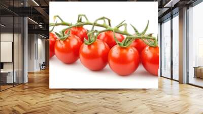 A fresh cluster of red cherry tomatoes attached to a green vine, set against a white background, highlighting their vibrant color and ripe appearance. Wall mural