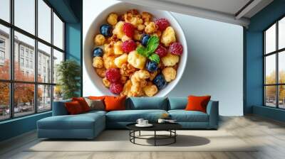 A bowl of cereal with blueberries and raspberries, topped with mint leaves. Wall mural