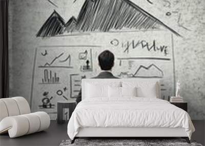 A businessman analyzes data and graphs on a wall, symbolizing strategic planning. Wall mural