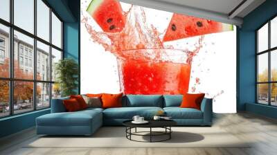 A glass of watermelon juice with two slices of watermelon on top, splashing with water droplets against a white background. Wall mural