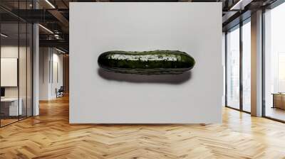 A crisp, fresh cucumber, meticulously isolated on a pure white background Wall mural