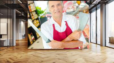 a butcher is holding knives Wall mural