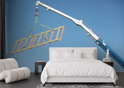 a crane lifting a wood structure. Wall mural