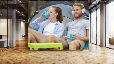 a young couple outside tent Wall mural