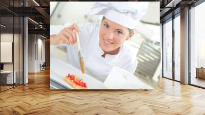 Baker brushing her pastries Wall mural