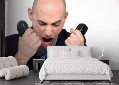 Bald man shouting into two telephones Wall mural