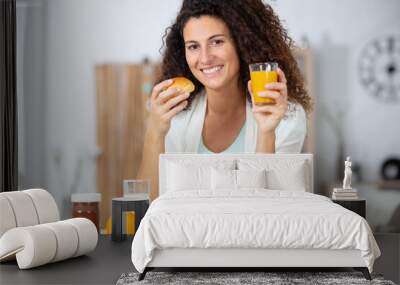 beautiful woman having glass of orange juice with her meal Wall mural