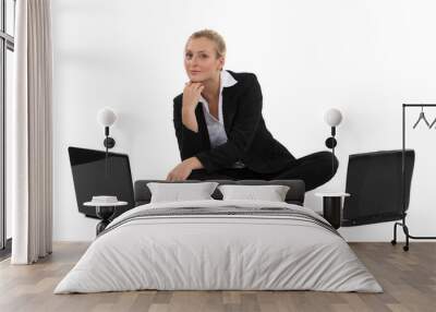 blond businesswoman sat on the floor with two laptops Wall mural