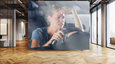 bored woman sitting in a car in traffic jam Wall mural