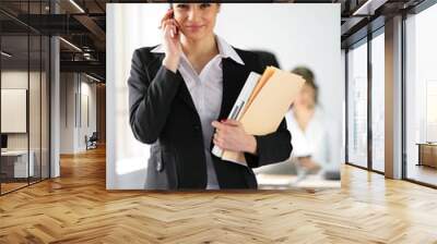 brunette holding folders and mobile telephone Wall mural