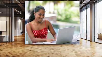 brunette sat poolside with her laptop Wall mural