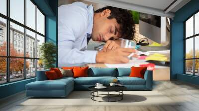 businessman in casual cloth sleeping at the table in office Wall mural