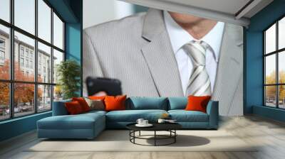 Businessman looking at phone Wall mural