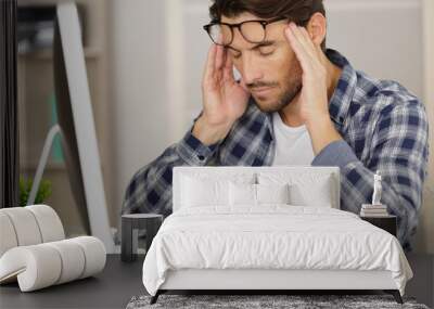 businessman with headache in office Wall mural