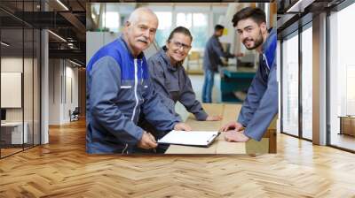 carpenter with woman and man apprentice in workshop Wall mural