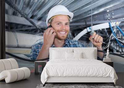 cheerful smiling builder working in the ceiling Wall mural