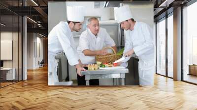 chef cooks meal with assistants Wall mural