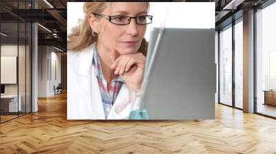 Chemist working at a laptop computer Wall mural