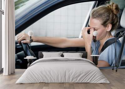 closeup portrait of young woman feels headache in her car Wall mural