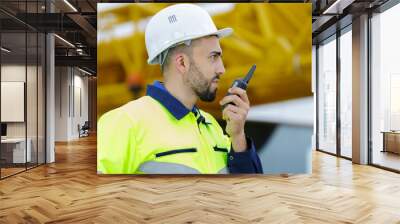 construction worker on site using walkie talkie Wall mural