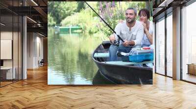 Couple fishing in a small boat on a river Wall mural