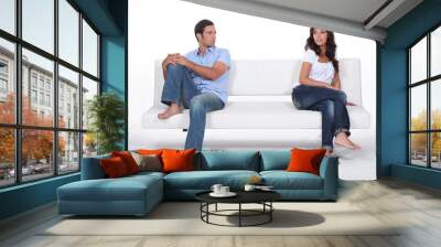 couple sitting apart in couch after quarrel Wall mural