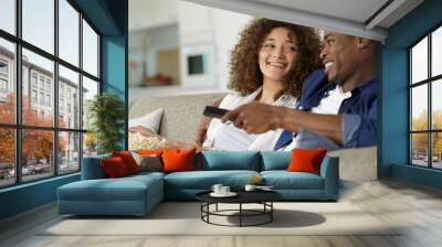 couple sitting on floor and watch tv with popcorn Wall mural