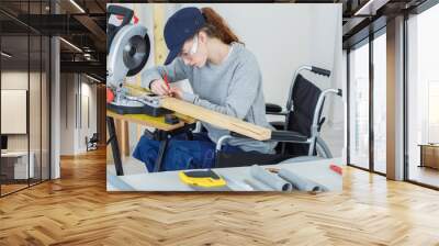 disabled female worker in wheelchair in a carpenters workshop Wall mural