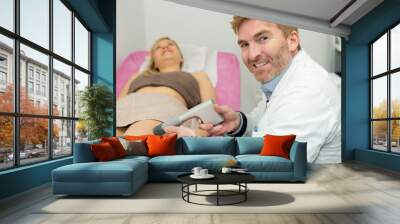 doctor treating the womans varicose in the hospital Wall mural