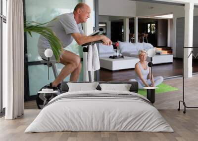 Elderly couple working out at home Wall mural