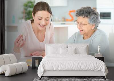 Elderly woman playing a board game Wall mural