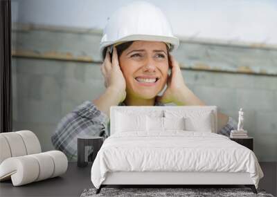 engineer construction worker woman covering ears Wall mural