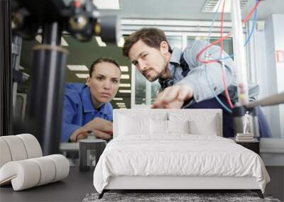 female apprentice electrical engineers in cable finishing factory Wall mural