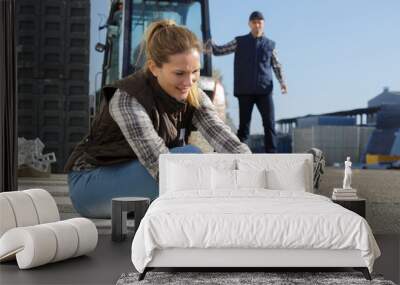 female builder putting working shoes on Wall mural