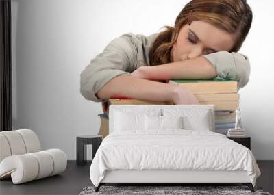 Female student asleep on her books Wall mural